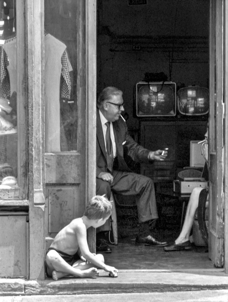 Boy Watches Man In Doorway